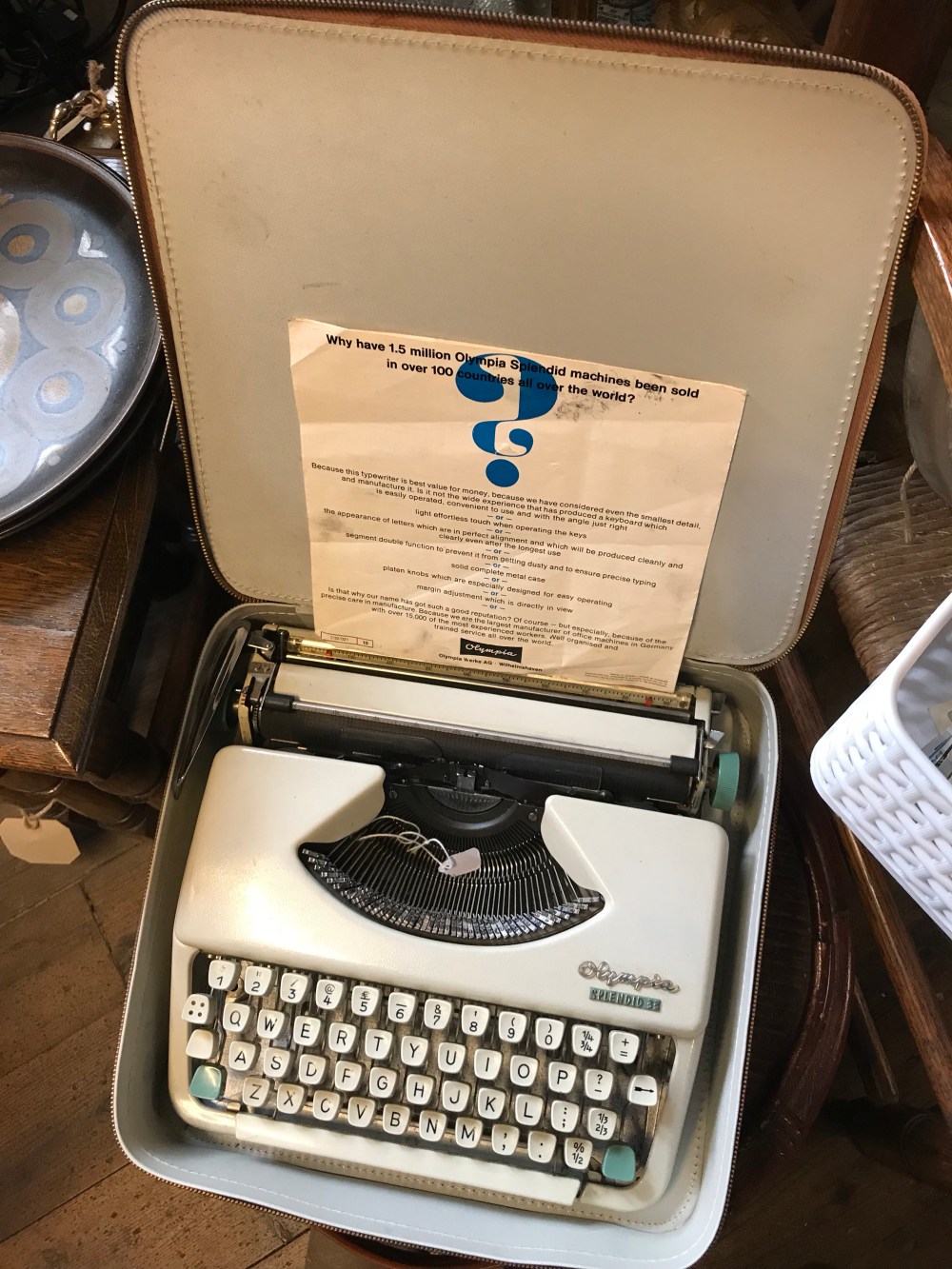 Vintage typewriter in travel case at an antiques shop